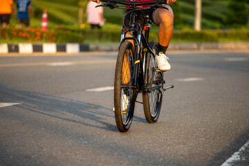 Fototapeta na wymiar sport man riding biking in the park at sunset background