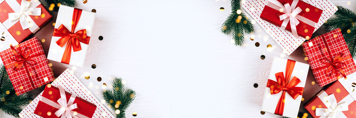 Banner made from festive gift boxes on wooden white background.