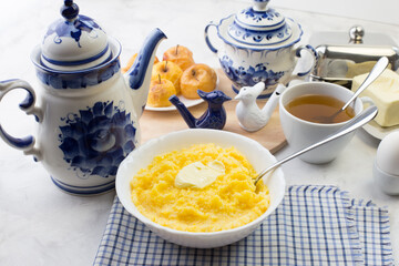 Delicious and healthy Breakfast with corn porridge and baked apples.