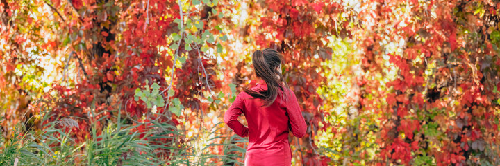 Autumn outside jogging woman runner running on red leaves background panorama. Banner header crop.