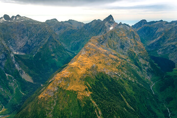 Obraz premium Amazing aerial view of colorful mountain range, on flight between Wanaka and Milford Sound, Fiordland, New Zealand