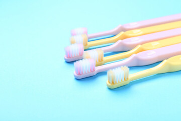 Tooth brushes on color background