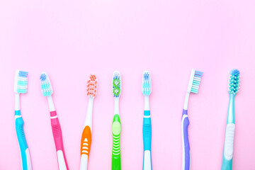 Tooth brushes on color background