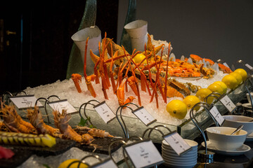 a buffet of seafood such as crab, prawns and crayfish on a bed of crushed ice
