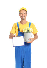 Delivery man with bouquet of flowers and clipboard on white background