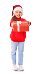 Cute little girl in Santa hat and with gift on white background
