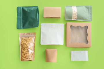 Packages for food on color background