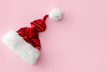 Santa Claus hat on color background