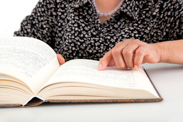 The elderly are carefully watching an opened book