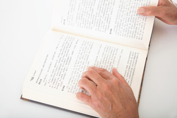Fototapeta premium The elderly are carefully watching an opened book
