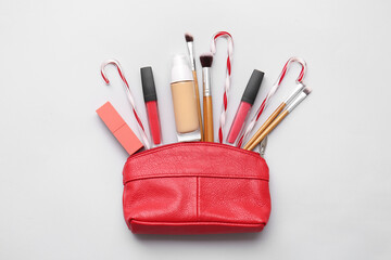 Christmas composition with cosmetics on light background