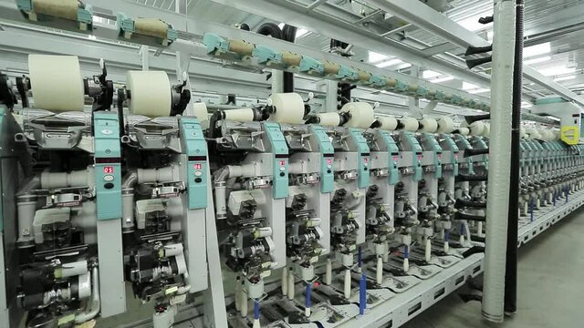 Factory for the production of cotton threads, machines wind the thread on large bobbins . Textile industry.
