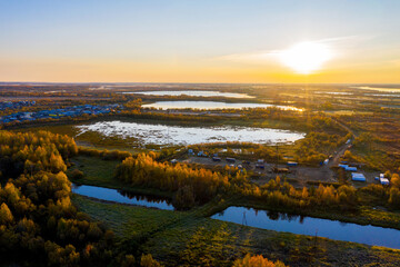 Swampy area with many lakes, in Western Siberia. Between the lakes there are bushes of oil wells . Shooting from a drone.