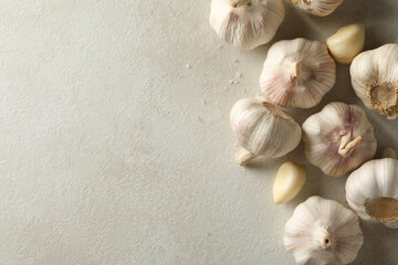 Raw garlic on light background, space for text