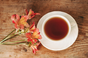cup of tea and flowers.  alstroemeria and a cup of tea. morning breakfast. beautiful still life