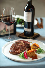 Grilled ribeye steak with potatoes with red wine