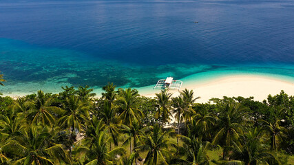 Beautiful lagoon and white sandy beach, aerial view. Perfect white sand beach with tropical trees. Mahaba Island, Philippines. advertising concept