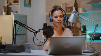 Content creator wearing headphones while recording new episode for podcast. Creative online show presenter On-air online production internet broadcast show host streaming live content, recording media