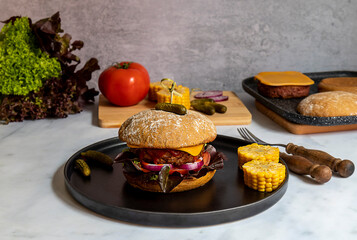 Beyond burger with vegan cheese, corns, onion, and pickles.