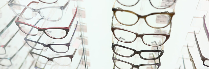 Showcase with glasses in optics salon. Collection of stylish frames concept