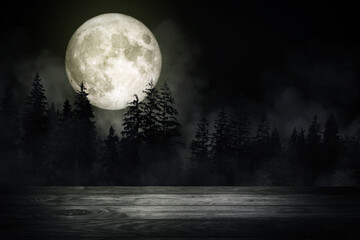 Wooden table top with forest in the dark night and fog or mist with full moon in background....
