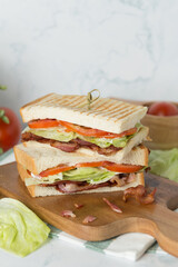 BLT Sandwich on Wooden plate decorate red tomato and lettuce
