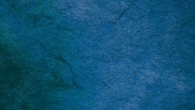 4K rain drop on heavy hard granite dark blue stone surface of cave for interior wallpaper background