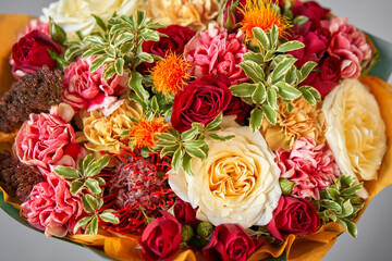 Autumn, Red tones Beautiful bouquet of mixed flowers in womans hands. the work of the florist at a flower shop. Handsome fresh bouquet. Flowers delivery