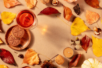 Autumn flat lay background with sweet wine, biscuits, autumn leaves, a flat lay layout with copyspace on a brown background