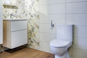 toilet and detail of a corner shower cabin with wall mount shower attachment