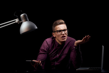 Male manager indoors dark background communication red shirt model glasses new technologies business finance