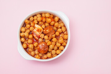 chick-pea with smoked sausage in white bowl