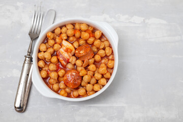chick-pea with smoked sausage in white bowl