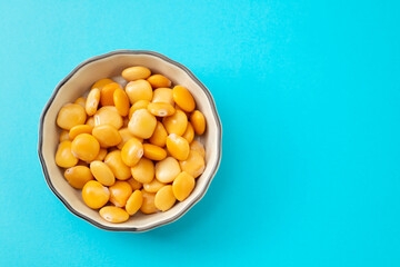 salted lupins in bowl on blue background