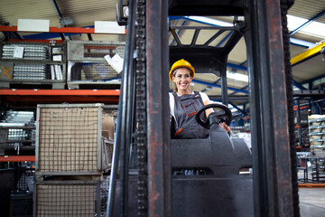 Professional industrial driver operating forklift machine in factory's warehouse. © littlewolf1989