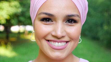 Close-up of a beautiful woman wearing a soft pink turban.