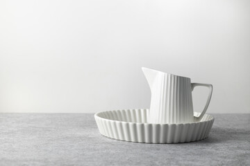 baking ceramic dish and milk jug on a light background