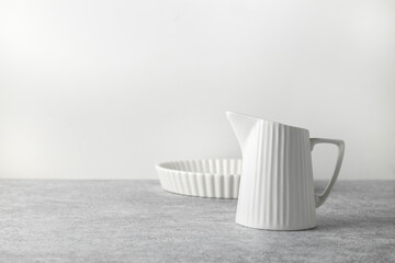 baking ceramic dish and milk jug on a light background