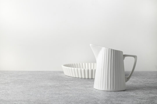 baking ceramic dish and milk jug on a light background