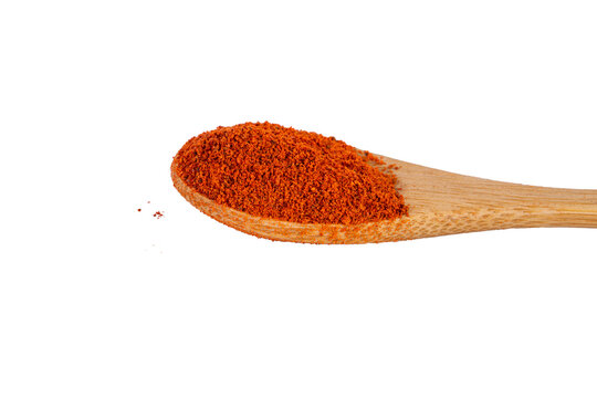 Heap of dried crushed hot red pepper on bamboo spoon. Macro