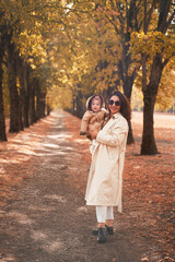 Fototapeta premium mother and little daughter walk in the autumn Park
