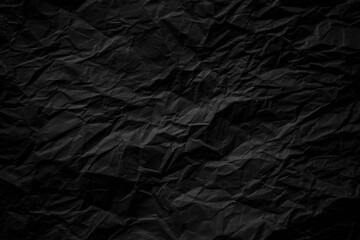 Dark black crumpled paper close up texture background