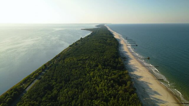 Kuznica tourist spot in Hel Peninsula, Poland, Slow aerial straight forward movement towards the horizon over the baltic sea