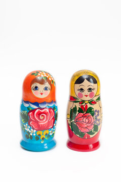 Russian doll. Two wooden dolls of different colors on a white background