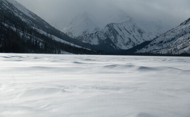 Obraz premium snow dunes against the background of winter mountains. Multinskie Lakes, Altai, Russia