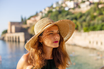 Summer travel concept. Young female in straw hat