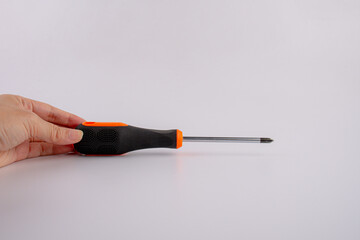 Orange screwdriver tools in hand isolated on white background 