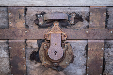 old rusty padlock on a wooden door