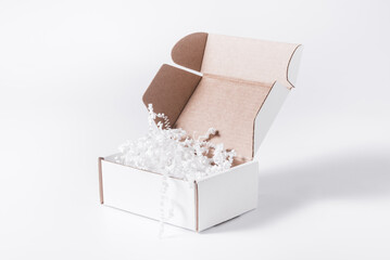 White cardboard, carton flat box with paper filler on background