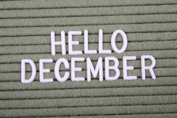 HELLO DECEMBER. White letters of the alphabet on a green background. Text and information